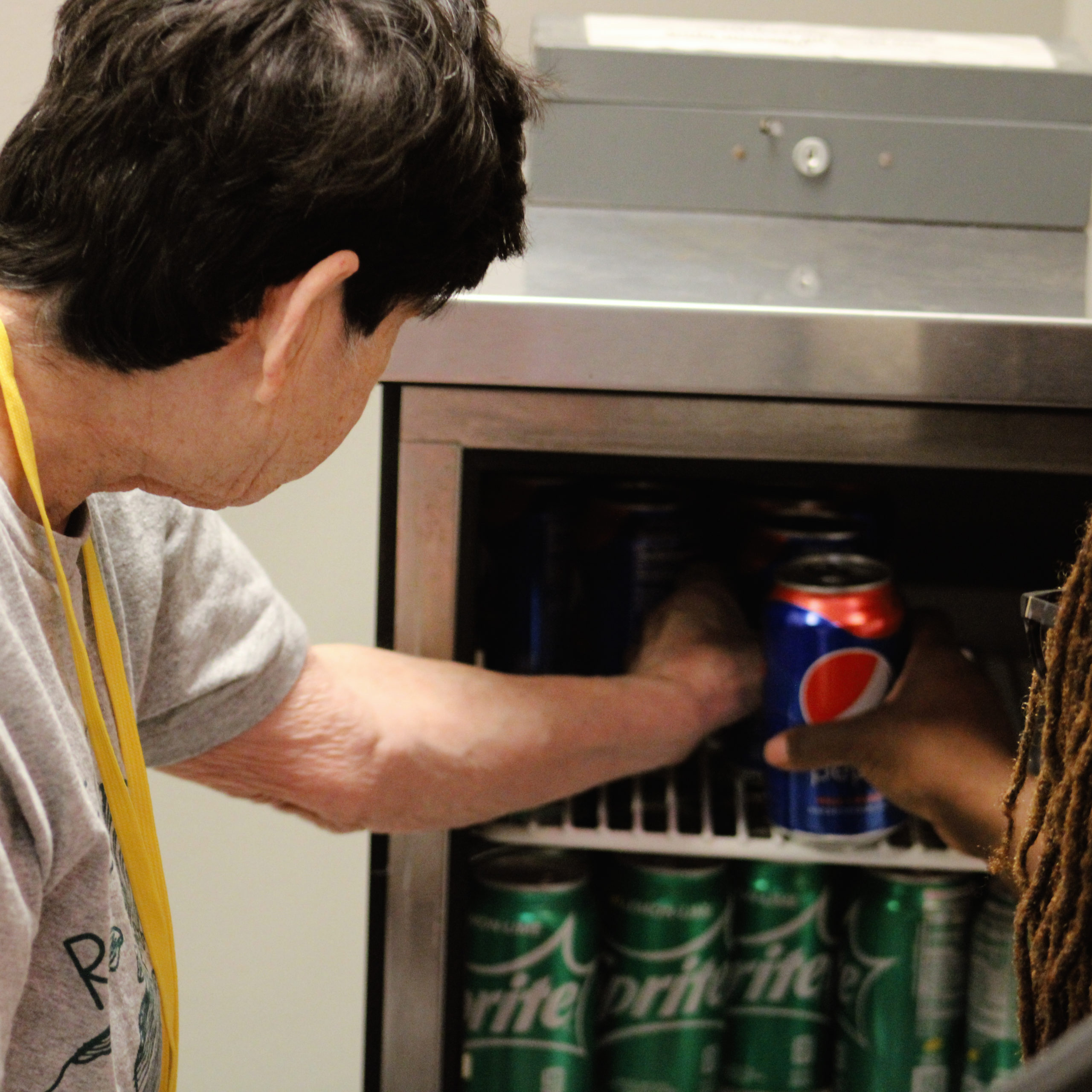 Kathleen stocks the fridge with soda