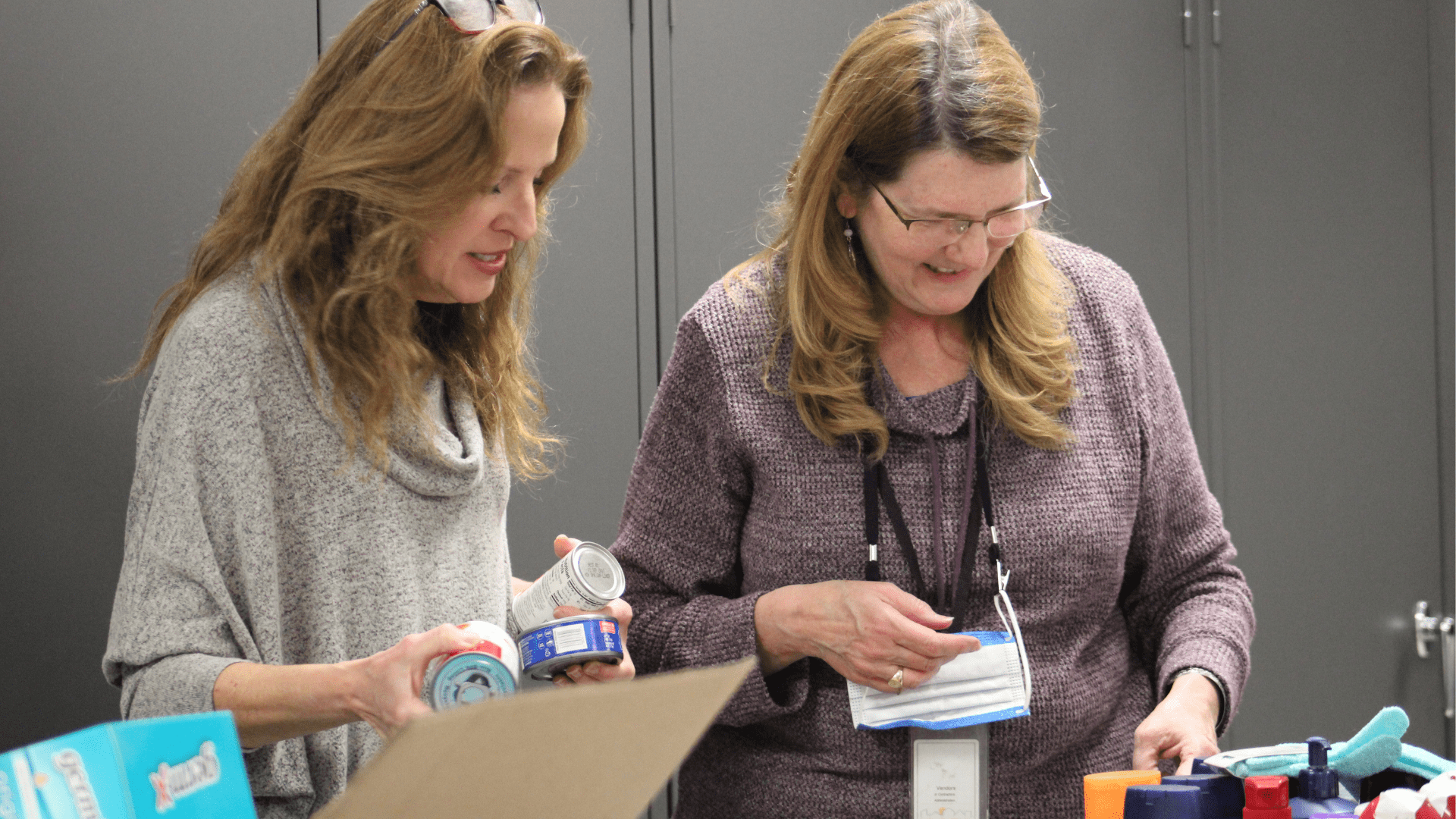 Volunteers packing gift bags with personal care items