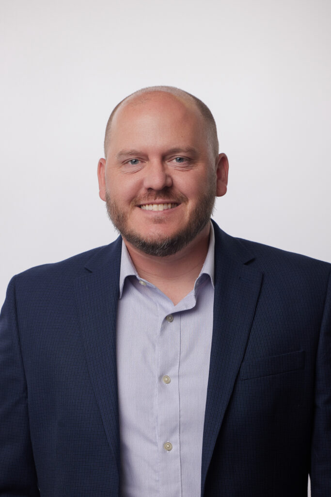 Dave Robben wearing a button-down shirt and suit jacket