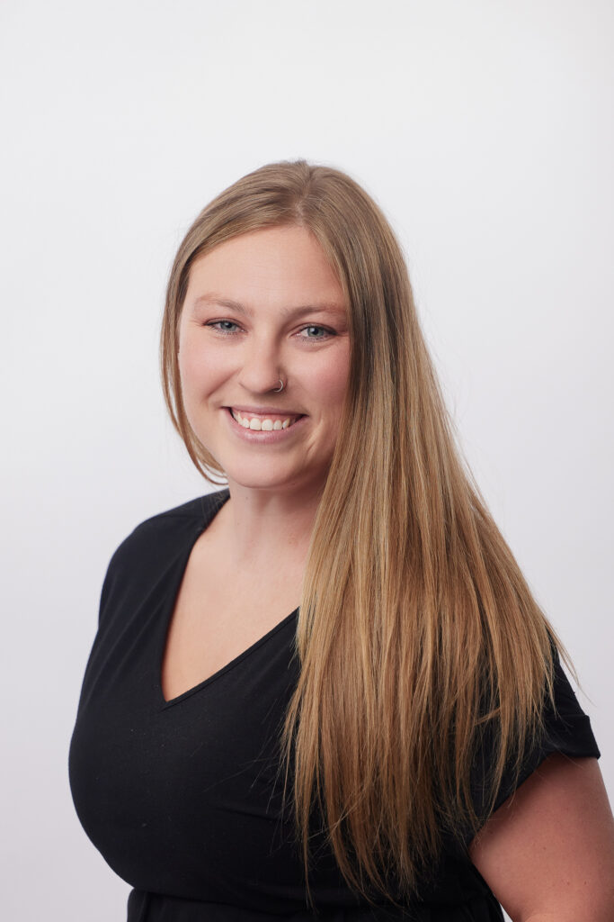 Dory Estes smiling with a blank background