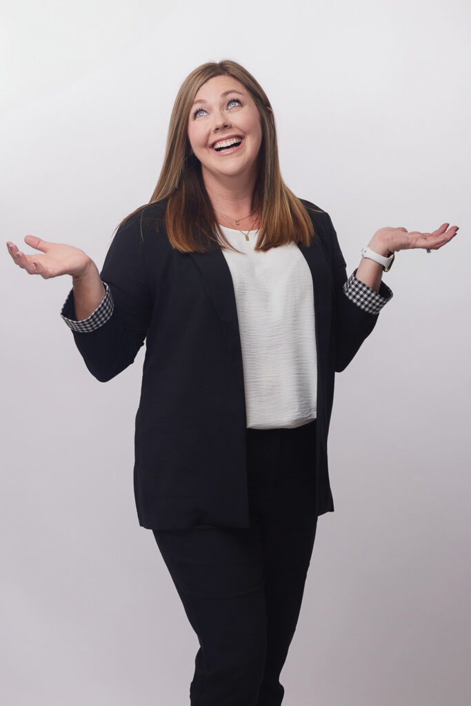 Michelle Martin-Yodis standing with her arms up and palms facing upward