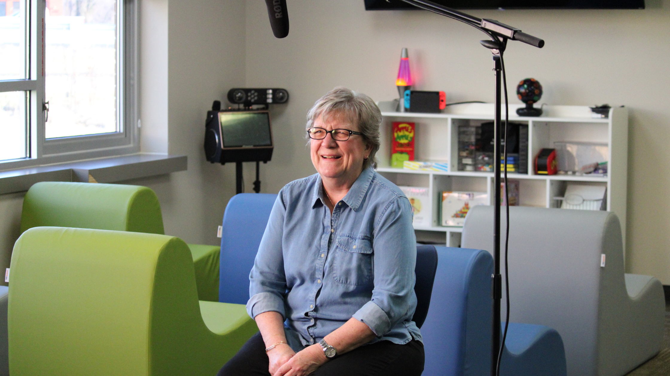 All Access Banner (1) President and CEO of Community Living sitting with a microphone hovering over her head
