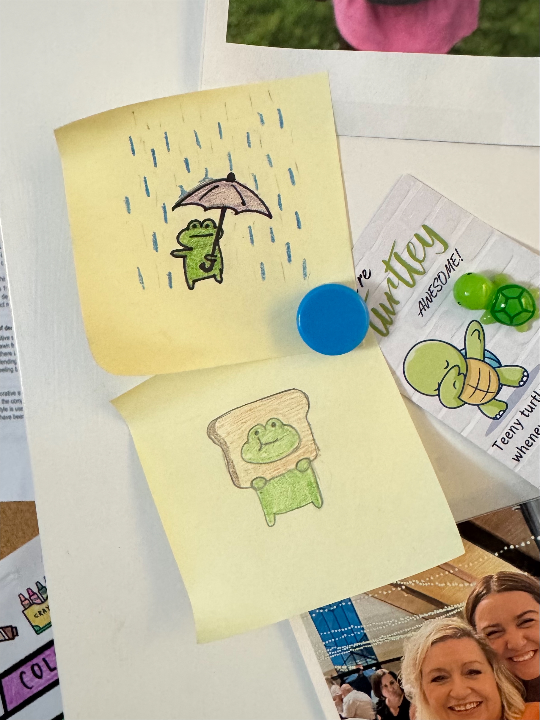 a couple of sticky notes with doodles of frogs
