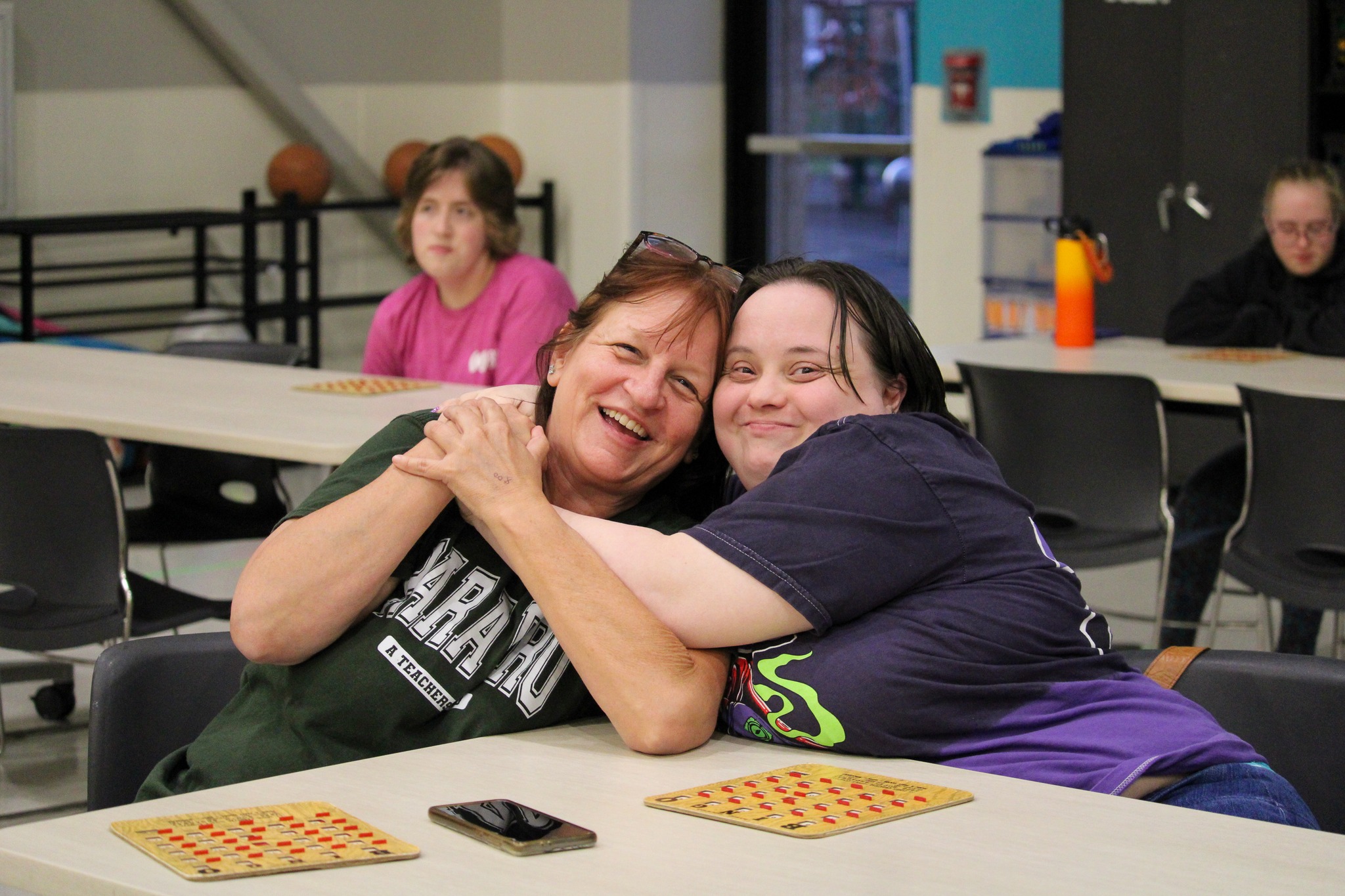Two people hugging and smiling